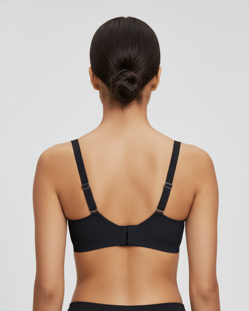 Woman wearing black wireless bra, back view showing adjustable straps and hook closure