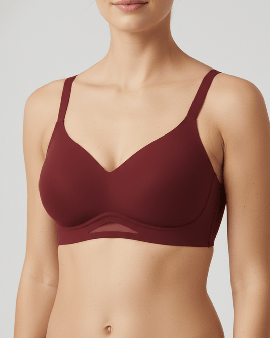 Woman wearing a wireless maroon plunge bra with breathable mesh detail, supportive fit