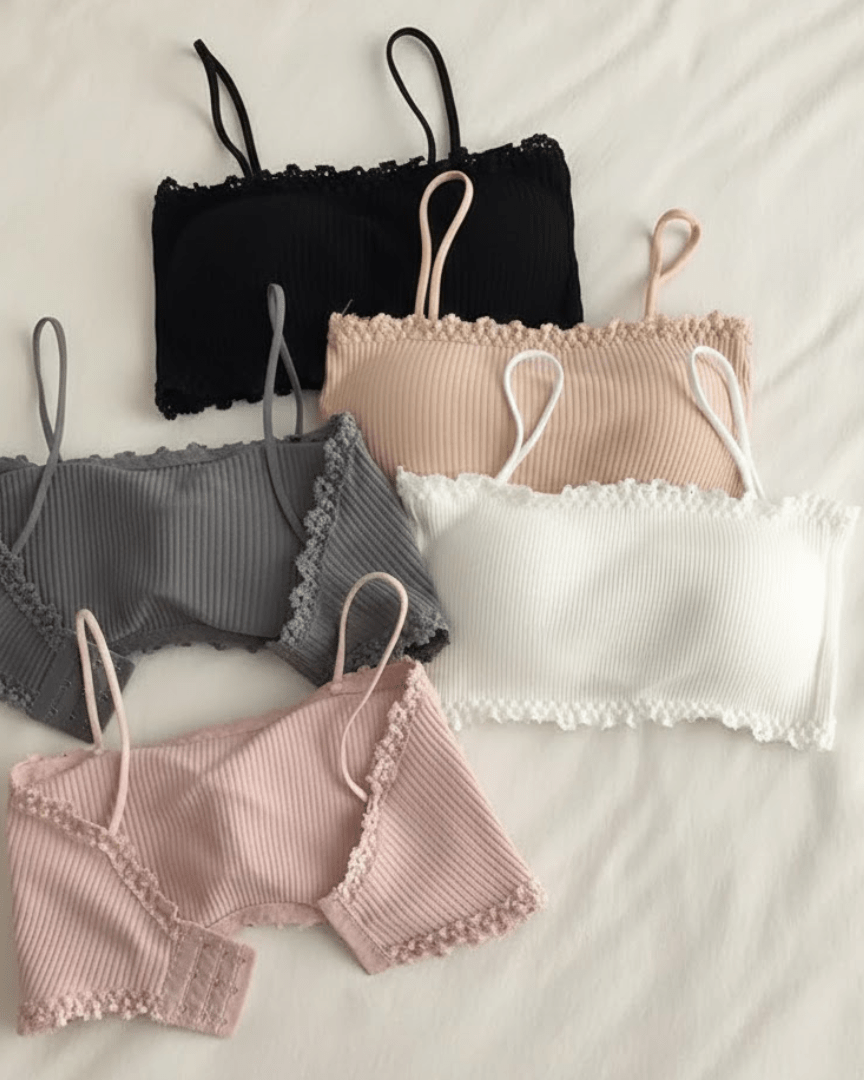 Assorted seamless cotton wireless bras in neutral colors with lace trim on a white background