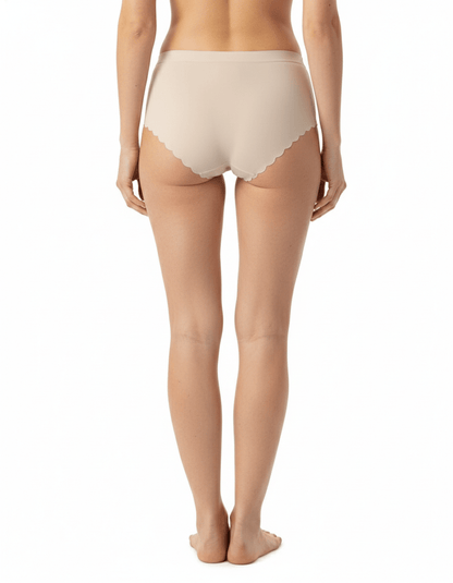 Seamless nude no-show panties with scalloped edges, shown on a model from the back.
