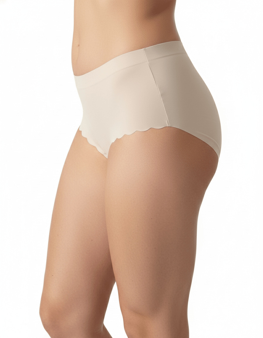 Seamless no-show beige panties with scalloped edges on a model, invisible under clothes
